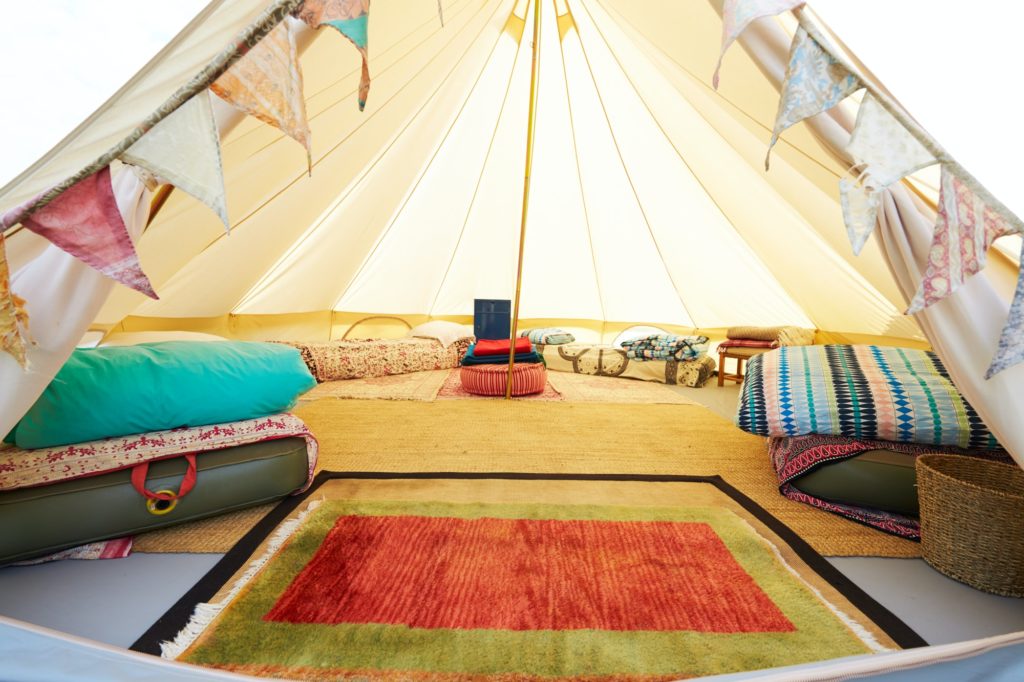 Interior View Of Teepee Tent Pitched On Glamping Camp Site With No People - camping checklist