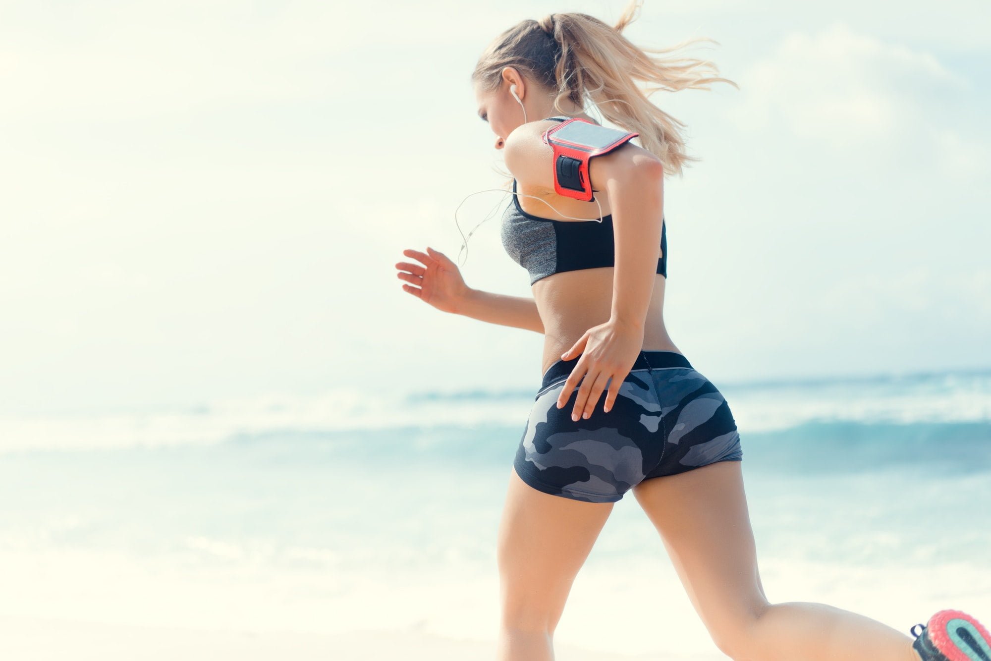 Running woman on beach