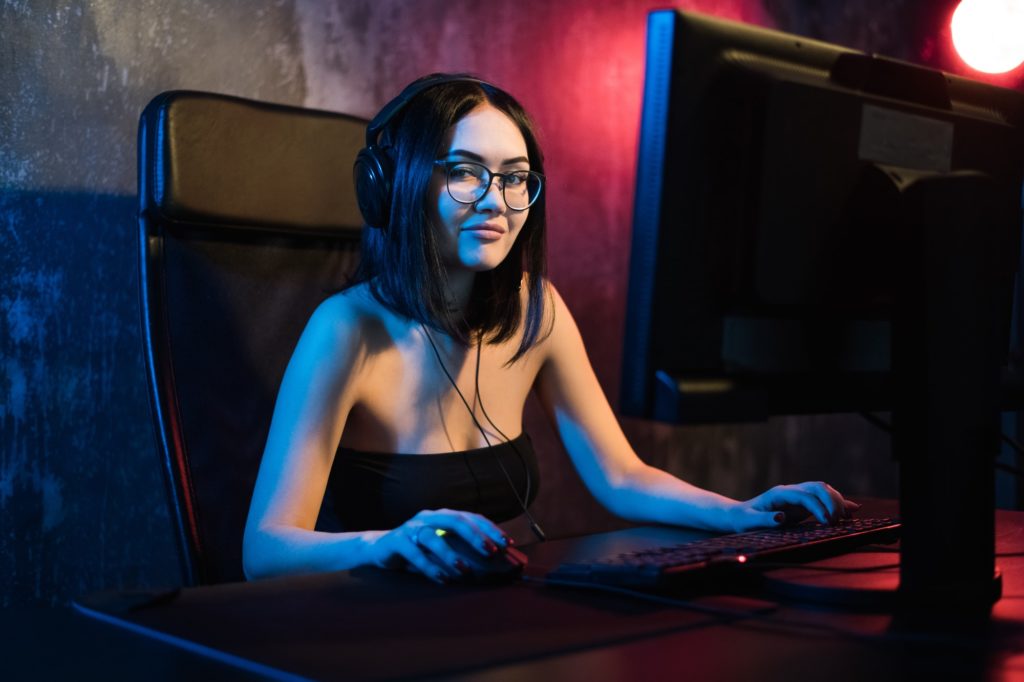 Portrait of the beautiful professional gamer girl playing in online video game, casual cute geek