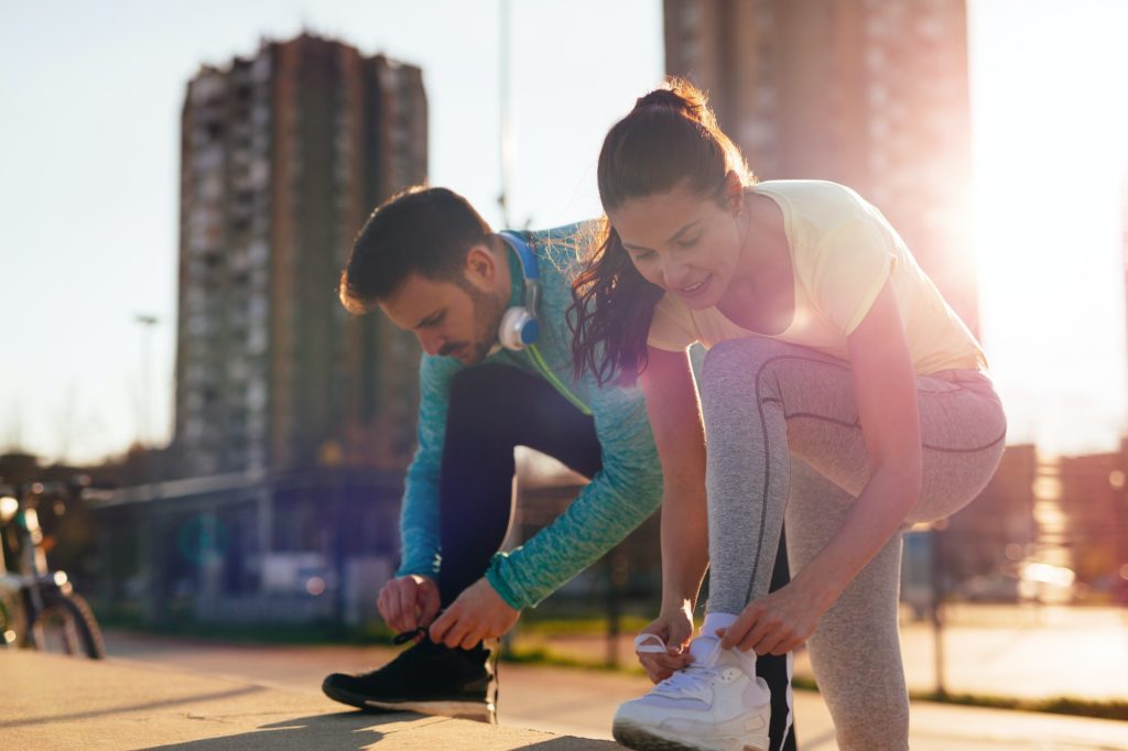 Runners tying running shoes and getting ready to run