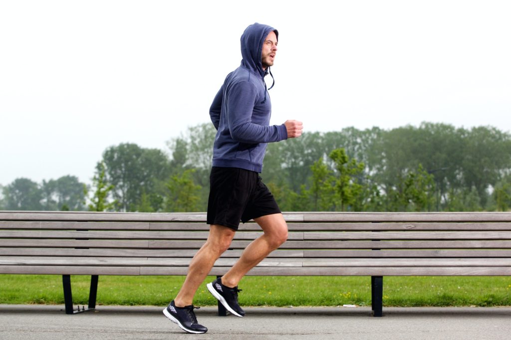 Sporty older man running in park