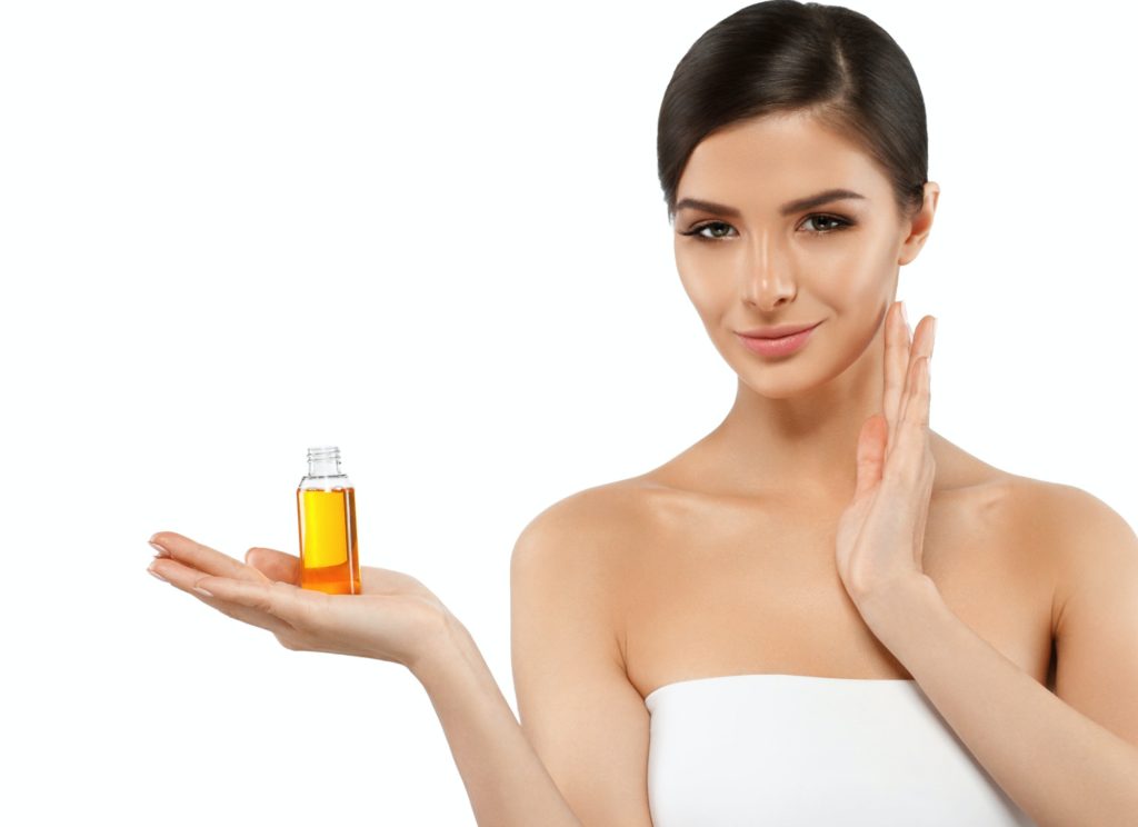 Woman with oil cosmetic beauty skin care concept. Young female model spa with oil skincare