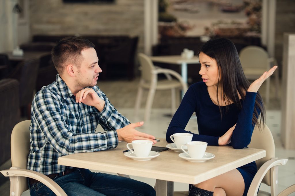 Young couple arguing in a cafe. Relationship problems.