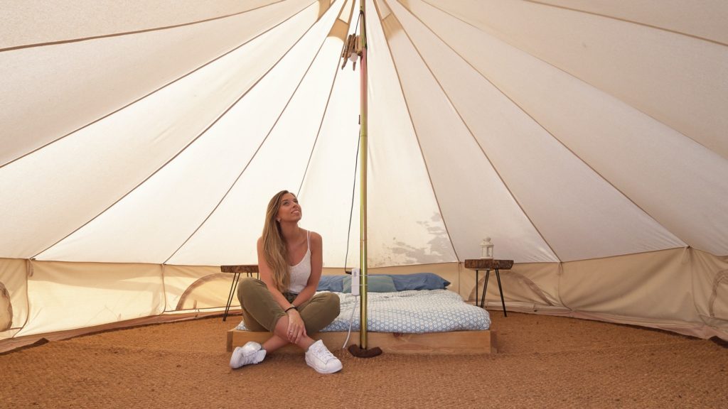 Young woman on the interior of a camping tent