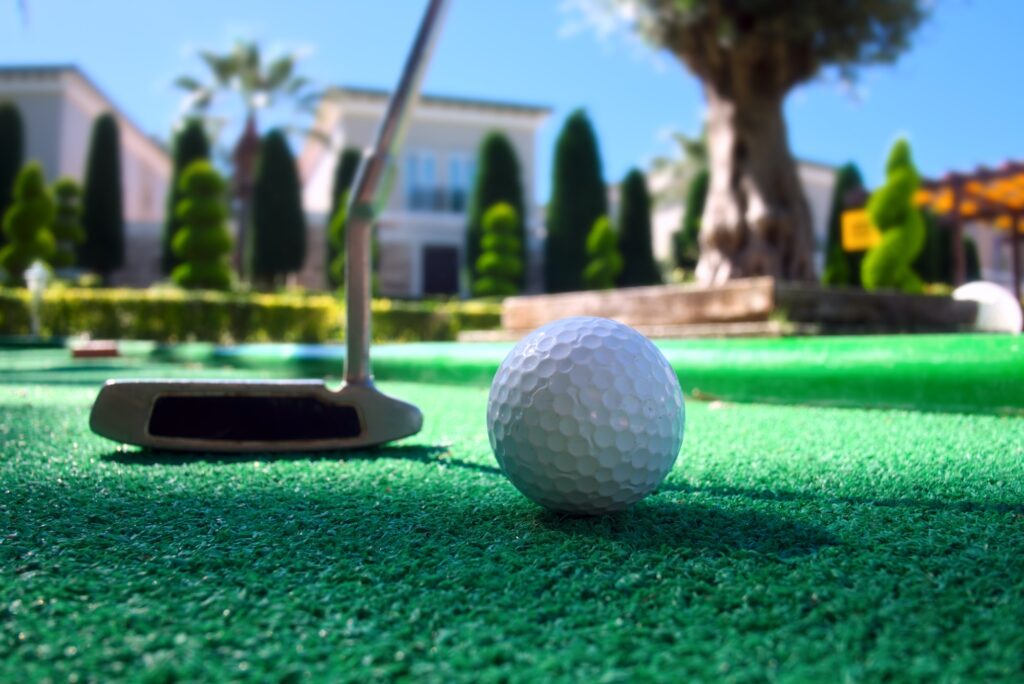 Mini golf scene with ball and club